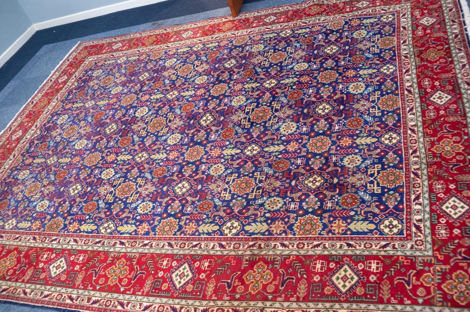 TABRIZ PERSIAN CARPET with all-over repeat formal floral, leaf and ram's horn patetrn on a dark blue