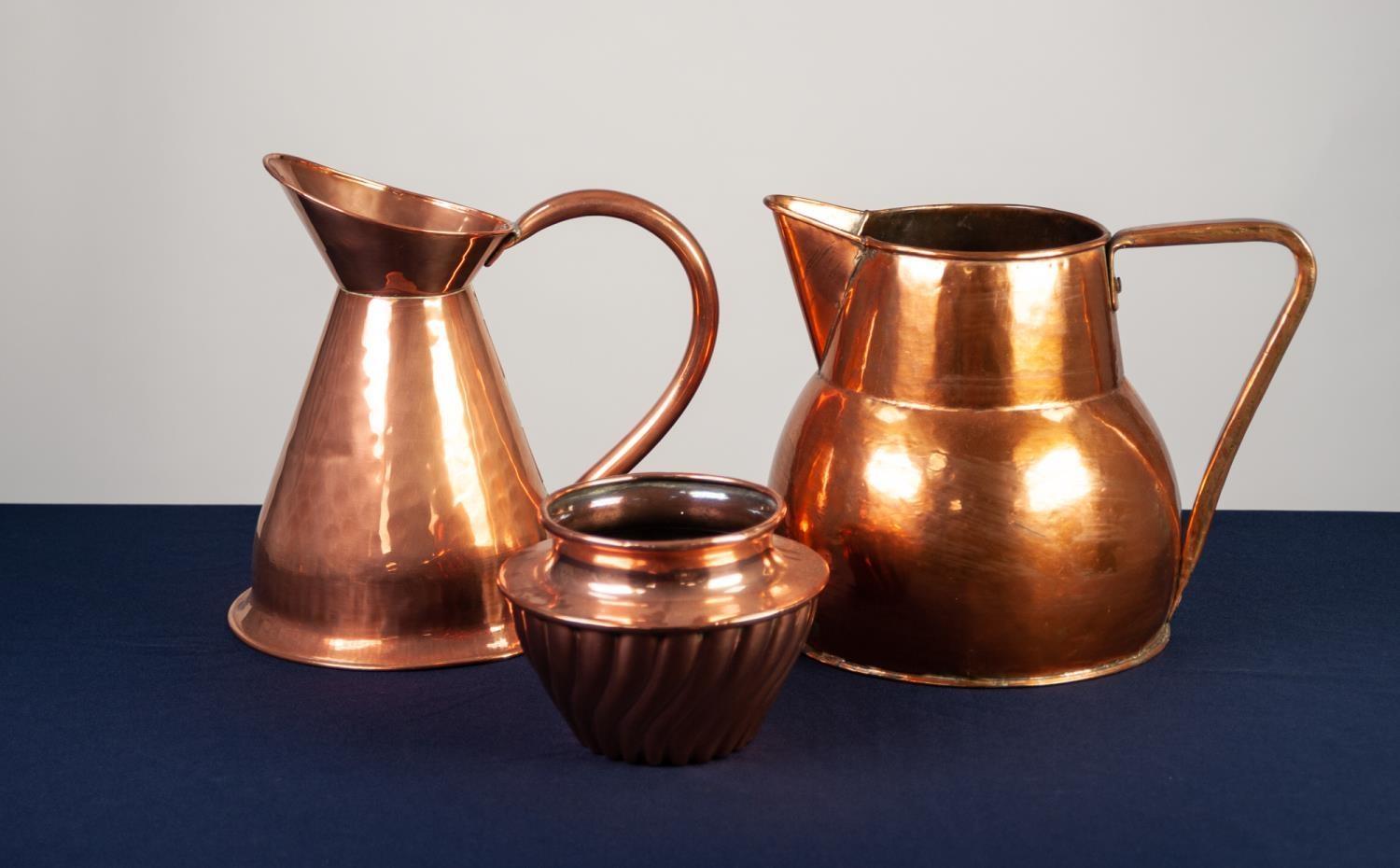 SEAMED COPPER HARVEST JUG, 11 ½? (29.2cm) high, together with a LARGER COPPER JUG, of bellied form