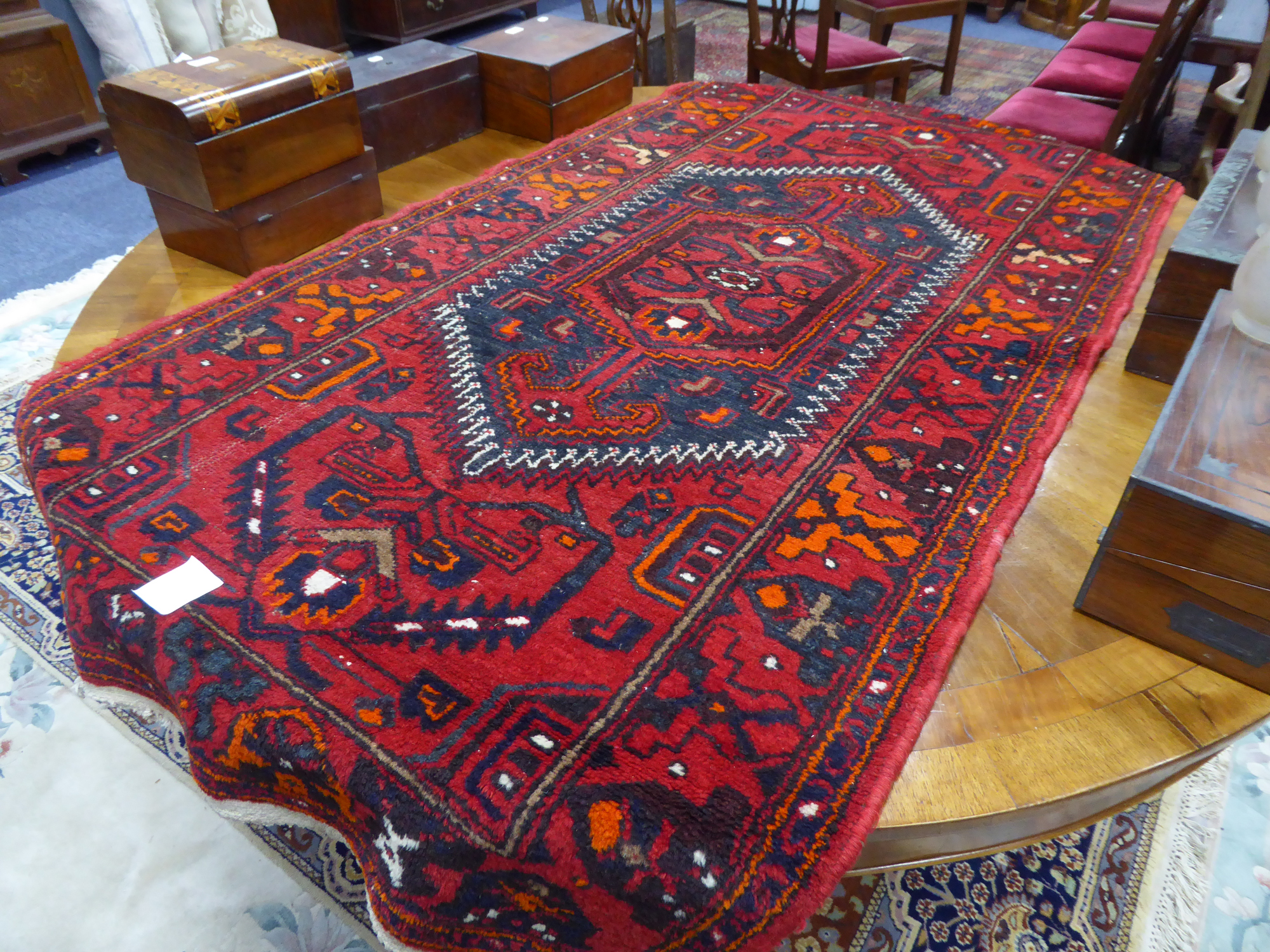 KHAMSEH EASTERN RUG, the hexagonal centre medallion having arrow pattern pendants, within a white