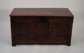 EIGHTEENTH CENTURY CARVED OAK COFFER, of typical form, the three panelled front carved with stylised