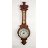LATE VICTORIAN CARVED OAK ANEROID BAROMETER, the 8? dial set beneath a mercury thermometer to the