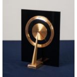 UNUSUAL AND RARE, CIRCA 1970, JAEGER LE COULTRE BLACK PERSPEX AND BRASS DESK CLOCK of sundial form