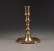 ANTIQUE BRASS CANDLESTICK,  with cylindrical sconce double knopped baluster column, standing on a