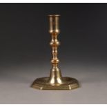 ANTIQUE BRASS CANDLESTICK,  with cylindrical sconce double knopped baluster column, standing on a