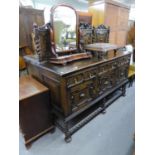 AN EDWARDIAN LARGE CARVED OAK SIDEBOARD, WITH PANELLED LEDGE BACK, THREE DRAWERS ABOVE THREE