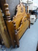 A MODERN CARVED PINE 4?6? PANEL BEDSTEAD, WITH SLATTED WOOD BASE