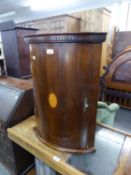 A MAHOGANY SMALL BOW FRONTED CORNER CABINET WITH OVAL SHELL INLAY DECORATION