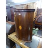 A MAHOGANY SMALL BOW FRONTED CORNER CABINET WITH OVAL SHELL INLAY DECORATION