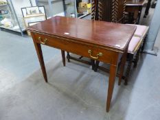 A MAHOGANY GOOD QUALITY CARD TABLE WITH FLIP TOP AND LONG DRAWER BELOW, RAISED ON SQUARE  TAPERING