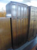 A CARVED OAK HALL WARDROBE WITH FIVE PANEL FRONT