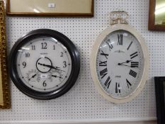 A MODERN ACU-RITE CIRCULAR WALL CLOCK/HYDROMETER AND THERMOMETER, IN BLACK METAL CIRCULAR CASE AND A