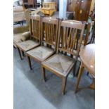 A SET OF SIX OAK DINING CHAIRS IN THE STYLE OF LIBERTY'S WITH RUSH SEATS  (6)