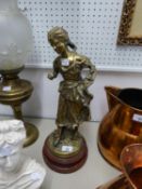 VICTORIAN STYLE CAST BRASS FIGURE OF A BAREFOOT GIRL GATHERING APPLES INTO HER GATHERED UP APRON, ON