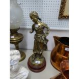 VICTORIAN STYLE CAST BRASS FIGURE OF A BAREFOOT GIRL GATHERING APPLES INTO HER GATHERED UP APRON, ON