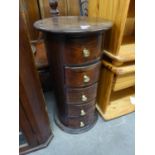 A MAHOGANY DRUM SHAPED CHEST OF FIVE DRAWERS WITH BRASS KNOB HANDLES