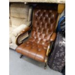 A REPRODUCTION BROWN LEATHER UPHOLSTERED REGENCY  REVIVAL CHAIR (BOTH BACK LEGS HAVING BEEN