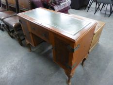 A DYNATRON WALNUT AND MAHOGANY CROSSBANDED RADIOGRAM, IN THE FORM OF A PEDESTAL DESK WITH GREEN