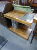 A MID CENTURY TEA TROLLEY WITH GLASS INSET TOP AND METAL COLUMNS