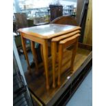 A NEST OF THREE LIGHT WOOD COFFEE TABLES WITH GLASS PROTECTORS