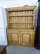 LARGE ANTIQUE PINE KITCHEN DRESSER, HAVING CUPBOARD DOORS, SHELVING AND SHAPED TOP