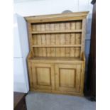 LARGE ANTIQUE PINE KITCHEN DRESSER, HAVING CUPBOARD DOORS, SHELVING AND SHAPED TOP