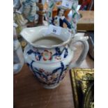 VICTORIAN FLORAL EMBOSSED POTTERY LARGE JUG, HIGHLIGHTED IN RED AND BLUE