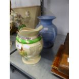 CROWN DEVON POTTERY MUSICAL JUG ?ON ILKLA MOOR BAHT?AT? AND AN ART DECO PALE BLUE TWO HANDLED RIBBED