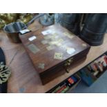 A WALNUTWOOD AND BRASS INLAID GAMES BOX, CONTAINING A SET OF DOMINOES, CHESS ETC...