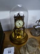 A BRASS ANNIVERSARY CLOCK UNDER GLASS DOME SHADE