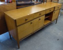 A TEAK SIDEBOARD WITH FOUR DRAWERS OVER FOUR CUPBOARDS (A.F.)