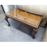 A CARVED AND FIGURED WALNUT OBLONG COFFEE TABLE WITH CARVED BORDER, ON FOUR ACANTHUS CARVED LEGS AND