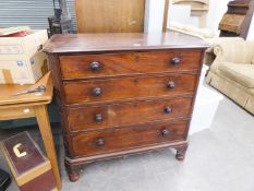 GEORGIAN MAHOGANY CHEST OF FOUR DRAWERS, with later, turned feet and blind fretwork to the canted