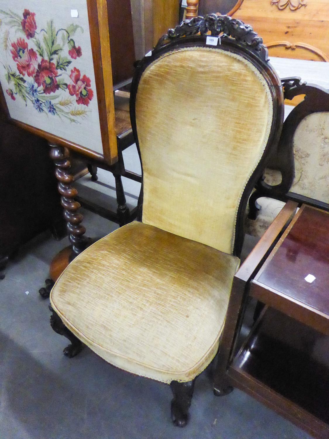 ANTIQUE MAHOGANY UPHOLSTERED NURSING CHAIR HAVING CARVED DETAIL