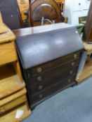 A MAHOGANY BUREAU WITH FOUR GRADUATED LONG DRAWERS BELOW, ON BRACKET FEET