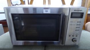 A SHARP STAINLESS STEEL CASED MICROWAVE