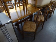 A MODERN PINE OBLONG KITCHEN TABLE AND FOUR ELM LADDER BACK SINGLE CHAIRS WITH RUSH SEATS