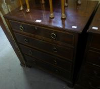 AN EDWARDIAN MAHOGANY CHEST OF FOUR GRADUATED LONG DRAWERS WITH BOXWOOD AND EBONY FEATHER BANDED