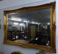 A LARGE OBLONG BEVELLED EDGE WALL MIRROR, IN GILT FRAME