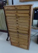 A PINE COLLECTOR'S CHEST OF 15 GRADUATED SHALLOW DRAWERS, EACH WITH A BRASS KNOB HANDLE, 13 1/2"