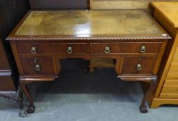 CHIPPENDALE STYLE CARVED MAHOGANY KNEEHOLE DESK WITH INLET LEATHER TOP, GADROON CARVED BORDERS, FOUR