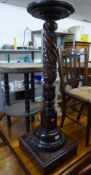 A MAHOGANY TORCHERE STAND WITH CIRCULAR TOP, TURNED AND SPIRALLY FLUTED AND ACANTHUS CARVED