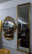 A MODERN GILT FRAMED CARTOUCHE SHAPED WALL MIRROR AND A ROBING MIRROR (2)