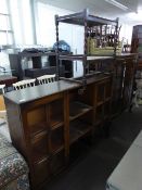 AN OAK SIDE-BY-SIDE DISPLAY CABINET WITH CENTRE SHELVES AND A TEA TROLLEY WITH BARLEY TWIST LEGS (2)