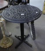 A BLACK CAST IRON PIERCED CIRCULAR TABLE ON COLUMN AND FLAT QUARTETTE BASE, 1'11" DIAMETER