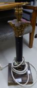 A BLACK ENAMELLED AND BRASS CORONTHIAN COLUMN TABLE LAMP, ON SQUARE STEPPED BASE, 14 3/4" HIGH AND