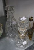 A LARGE CUT GLASS SHAPED STOPPER, WITH PLAIN SILVER NECK, 13? HIGH, AND A CUT GLASS CONICAL DECANTER