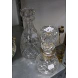A LARGE CUT GLASS SHAPED STOPPER, WITH PLAIN SILVER NECK, 13? HIGH, AND A CUT GLASS CONICAL DECANTER