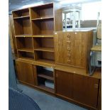 A TEAK G-PLAN STYLE STACKING UNIT OF FIVE SECTIONS, WITH THREE OPEN SHELVING SECTIONS, ONE NEST OF