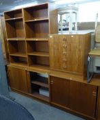 A TEAK G-PLAN STYLE STACKING UNIT OF FIVE SECTIONS, WITH THREE OPEN SHELVING SECTIONS, ONE NEST OF