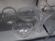 A LARGE CUT GLASS CIRCULAR BOWL RAISED ON THREE SCROLL FEET, 11 ½? DIAMETER; A CUT GLASS BASKET